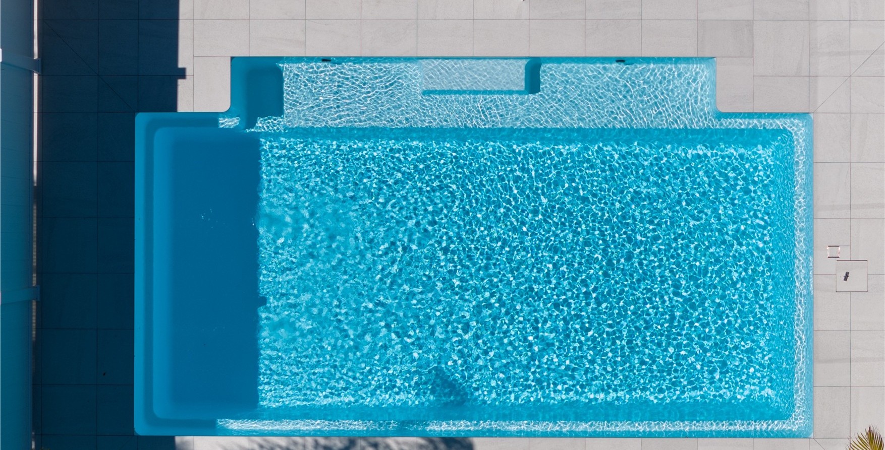 Aerial view of a Venice fibreglass pool framed by lawn and paving