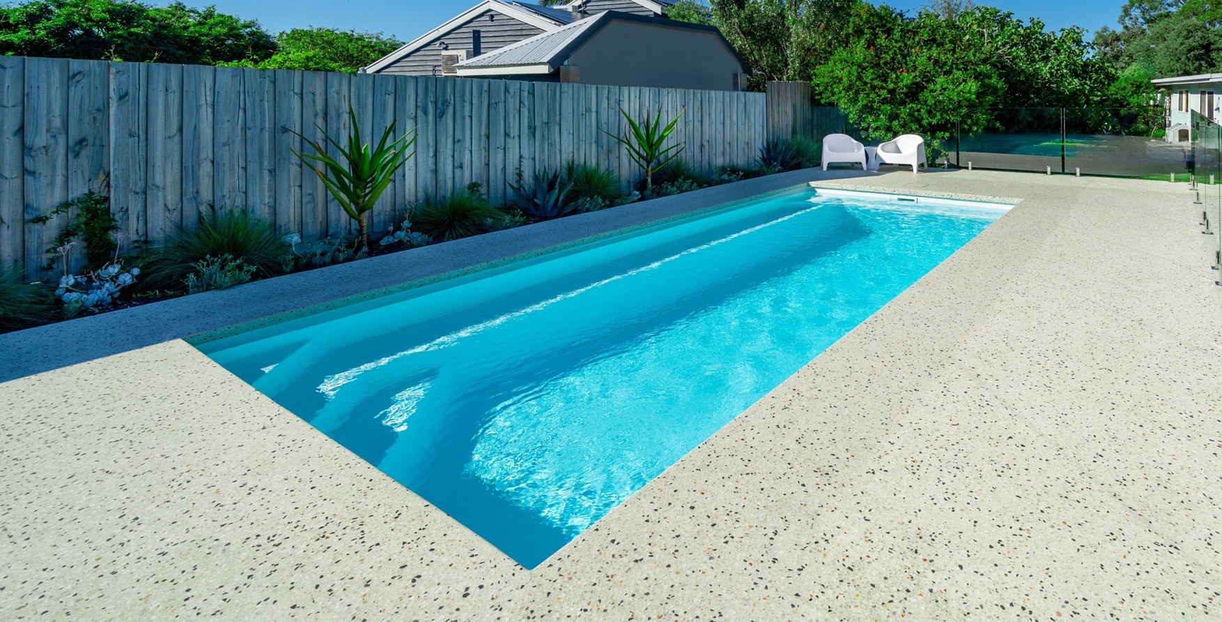 Brampton Slimline pool running along a fence line in a narrow backyard